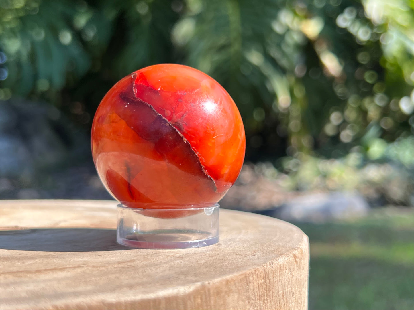 Vibrant Carnelian sphere with rich orange-red tones, celebrated for boosting confidence, motivation, and creative energy