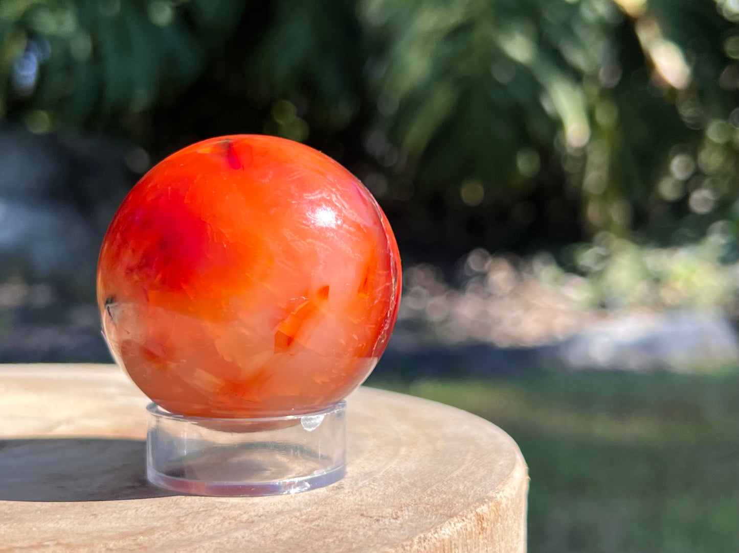 Vibrant Carnelian sphere with rich orange-red tones, celebrated for boosting confidence, motivation, and creative energy