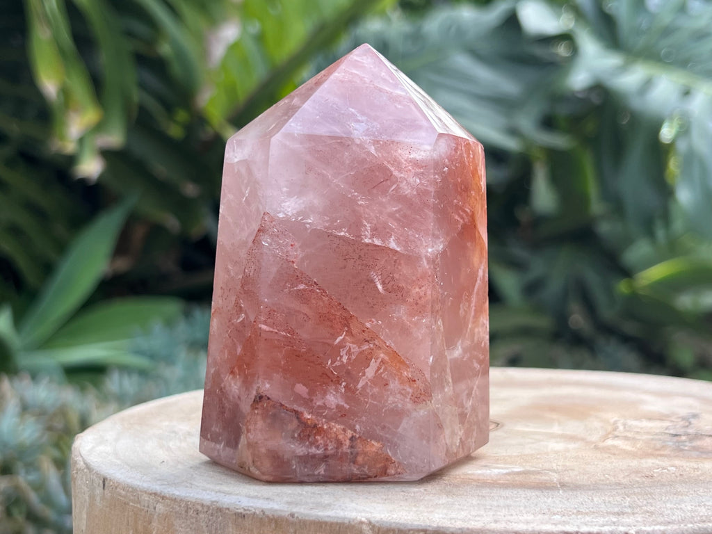 Hematoid Quartz point with clear and reddish-golden inclusions, combining the grounding energy of Hematite with the clarity of Quartz