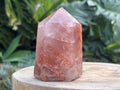 Hematoid Quartz point with clear and reddish-golden inclusions, combining the grounding energy of Hematite with the clarity of Quartz