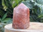 Hematoid Quartz point with clear and reddish-golden inclusions, combining the grounding energy of Hematite with the clarity of Quartz