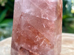 Hematoid Quartz point with clear and reddish-golden inclusions, combining the grounding energy of Hematite with the clarity of Quartz. This photo is a close up of the detail in the point 