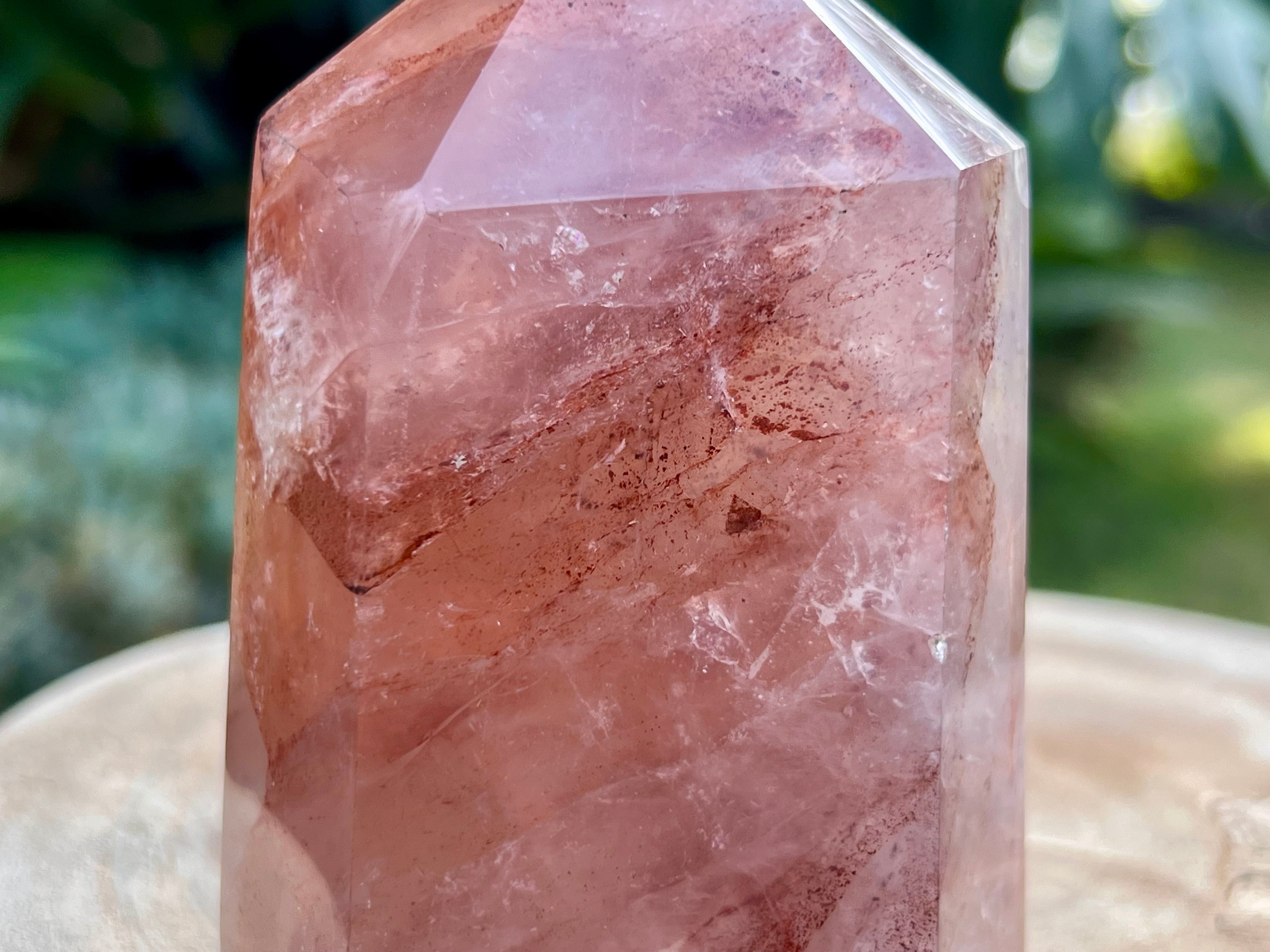 Hematoid Quartz point with clear and reddish-golden inclusions, combining the grounding energy of Hematite with the clarity of Quartz. This is a close up of the inclusions in the point 