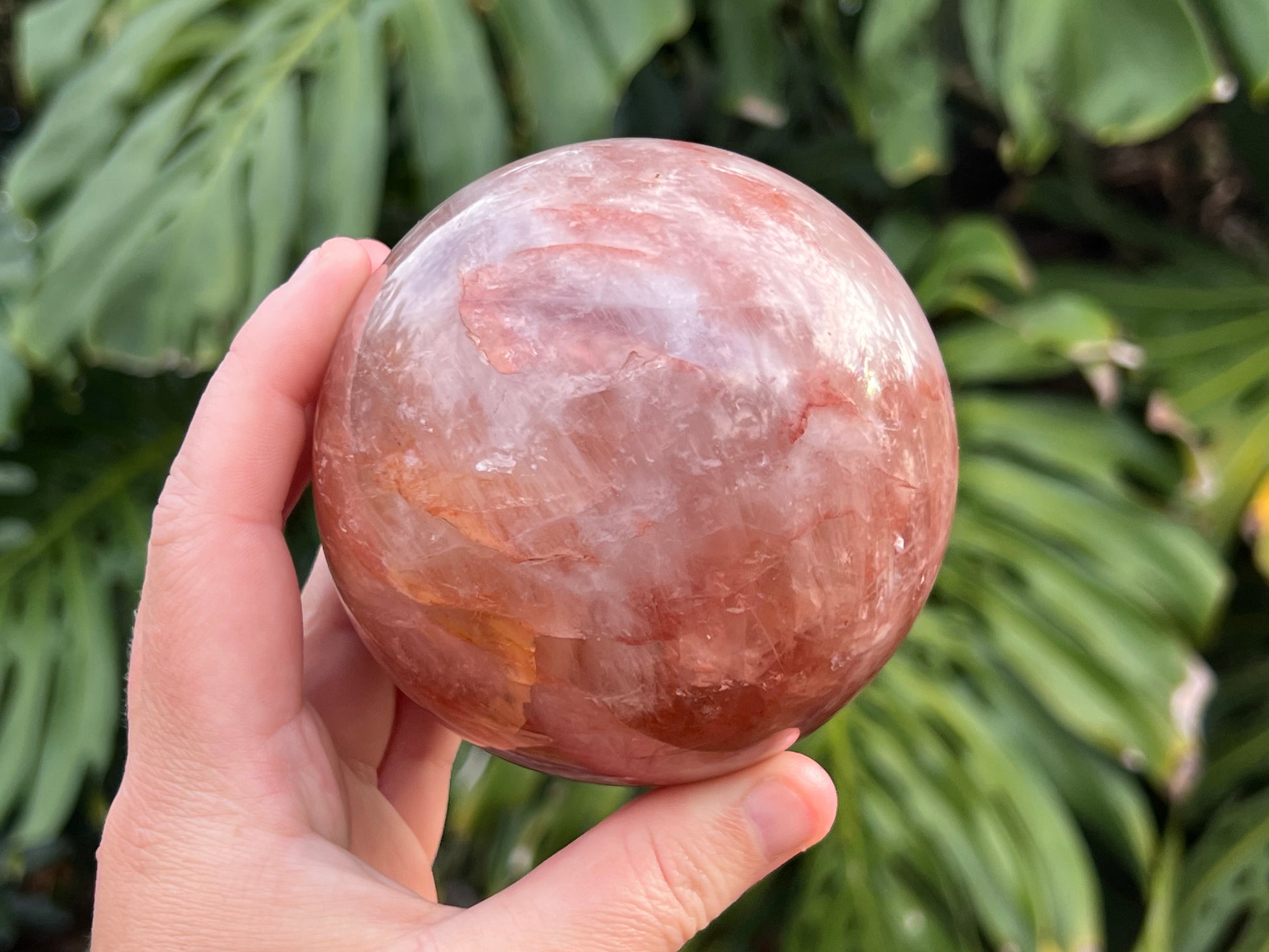 Hematoid Quartz sphere with clear and reddish-golden inclusions, combining the grounding energy of Hematite with the clarity of Quartz. In this photo I am holding the sphere to show the size 
