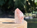 Hematoid Quartz point with clear and reddish-golden inclusions, combining the grounding energy of Hematite with the clarity of Quartz