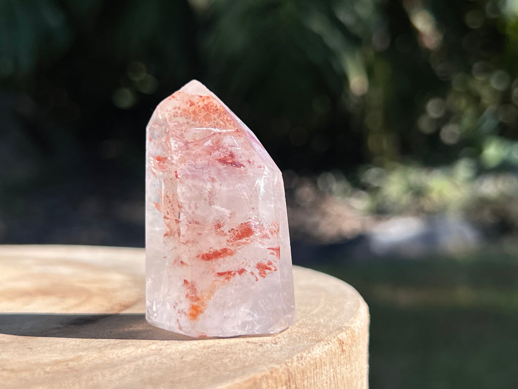 Hematoid Quartz point with clear and reddish-golden inclusions, combining the grounding energy of Hematite with the clarity of Quartz