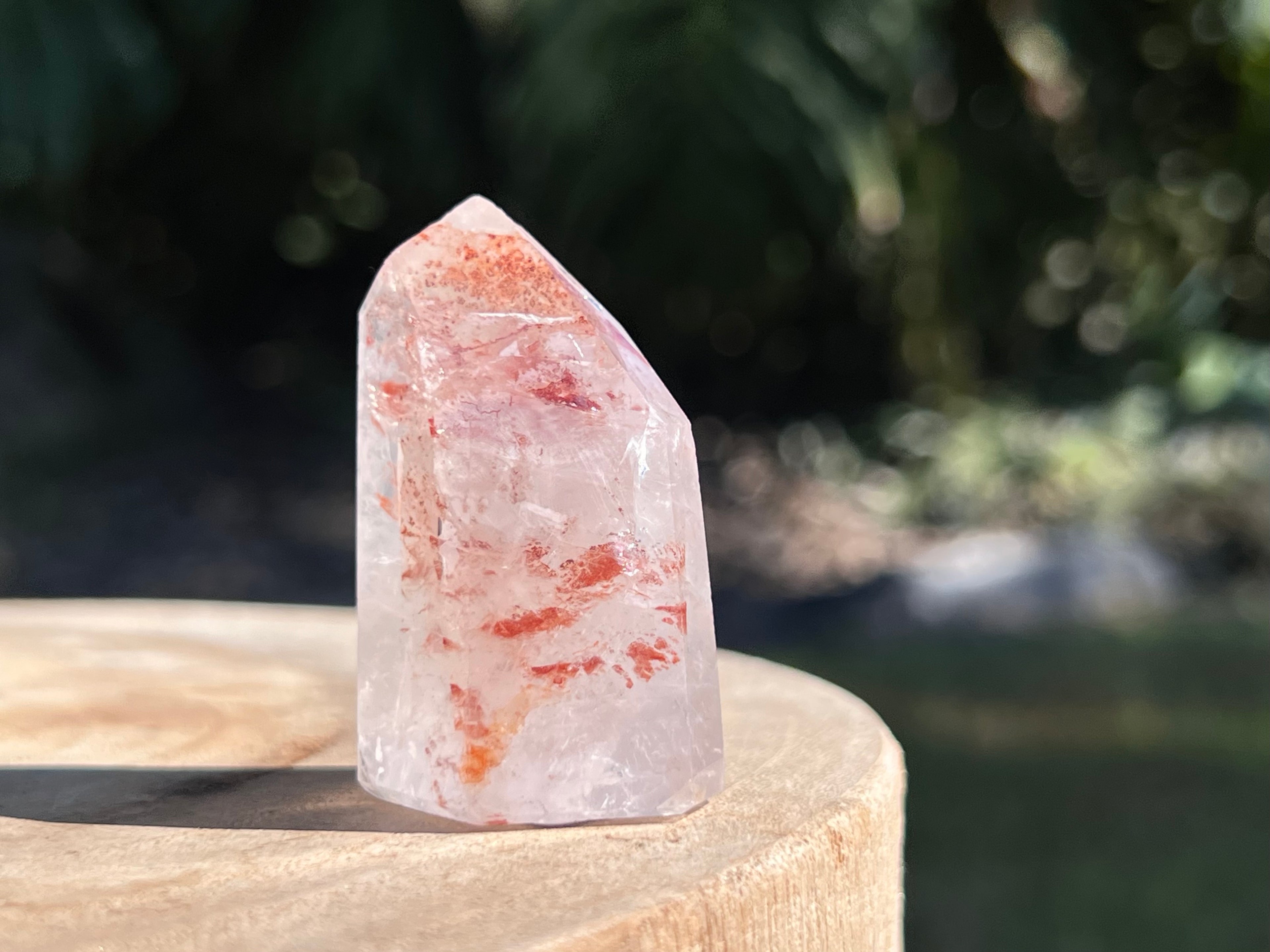 Hematoid Quartz point with clear and reddish-golden inclusions, combining the grounding energy of Hematite with the clarity of Quartz