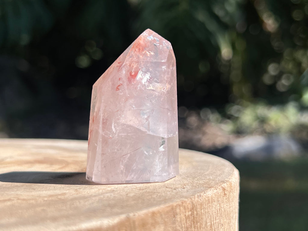 Hematoid Quartz point with clear and reddish-golden inclusions, combining the grounding energy of Hematite with the clarity of Quartz