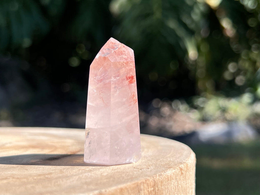 Hematoid Quartz point with clear and reddish-golden inclusions, combining the grounding energy of Hematite with the clarity of Quartz