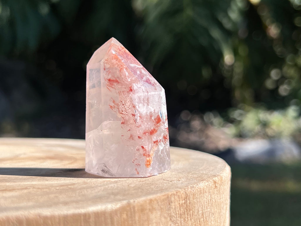 Hematoid Quartz point with clear and reddish-golden inclusions, combining the grounding energy of Hematite with the clarity of Quartz