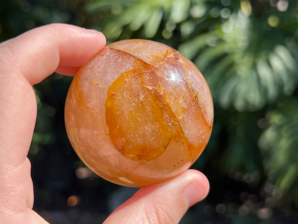 Golden Healer Quartz with warm golden hues and translucent clarity, known for its powerful healing energy and connection to divine light in my hand for a size guide 