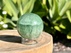 Green Fluorite sphere on a plastic sphere stand 
