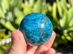 Blue apatite sphere in my hand for a size guide 