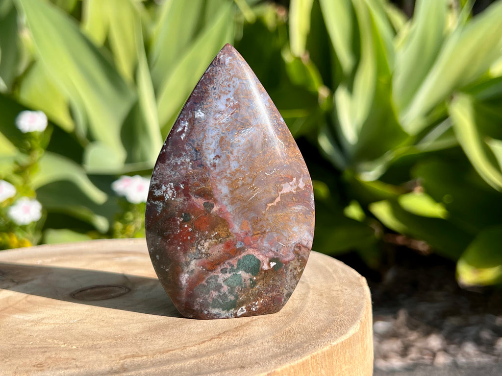 Ocean jasper other side of carved flam. Showing the stunning colours. Browns, reds, grey and a moss green