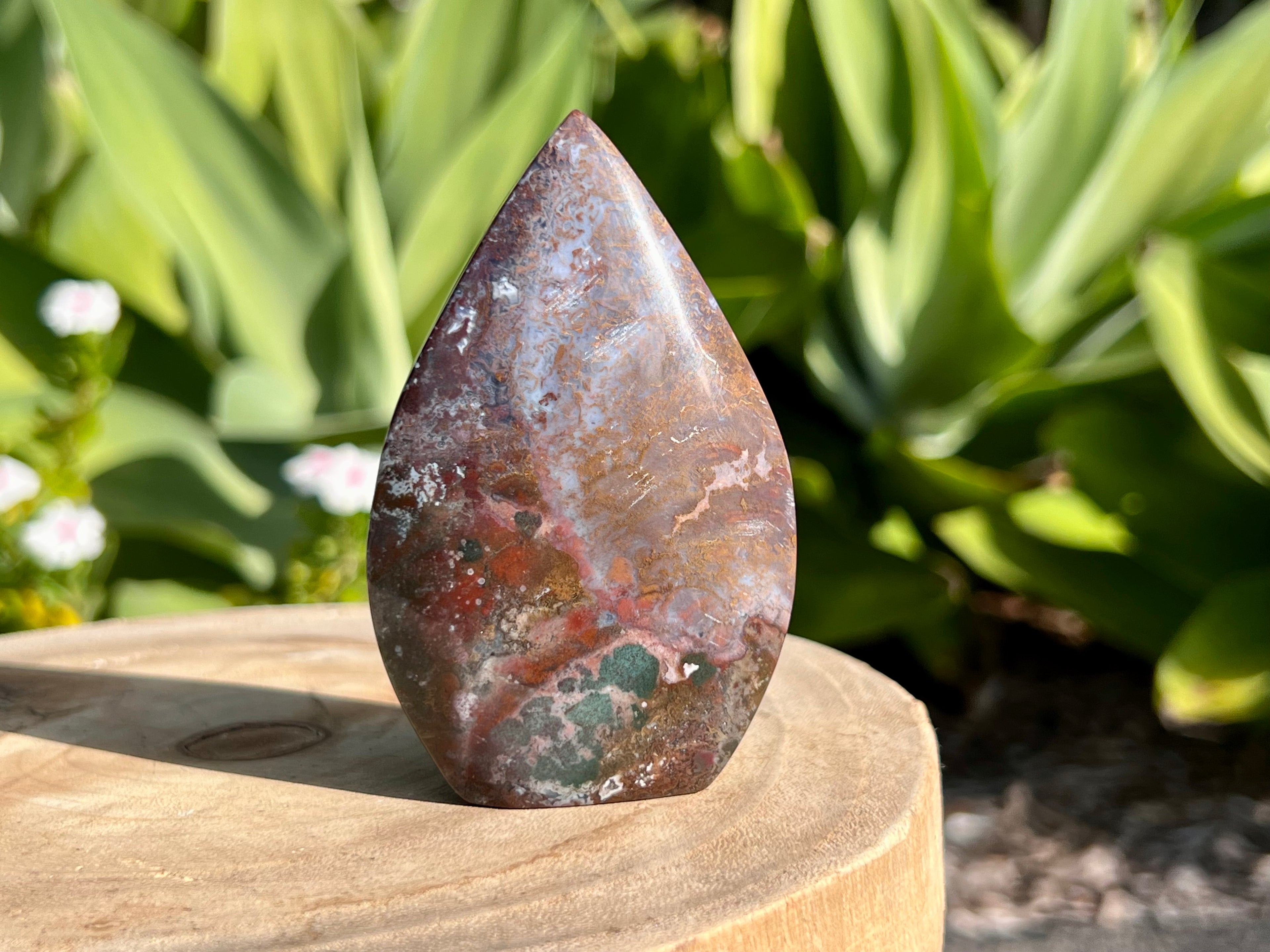 Ocean jasper other side of carved flam. Showing the stunning colours. Browns, reds, grey and a moss green